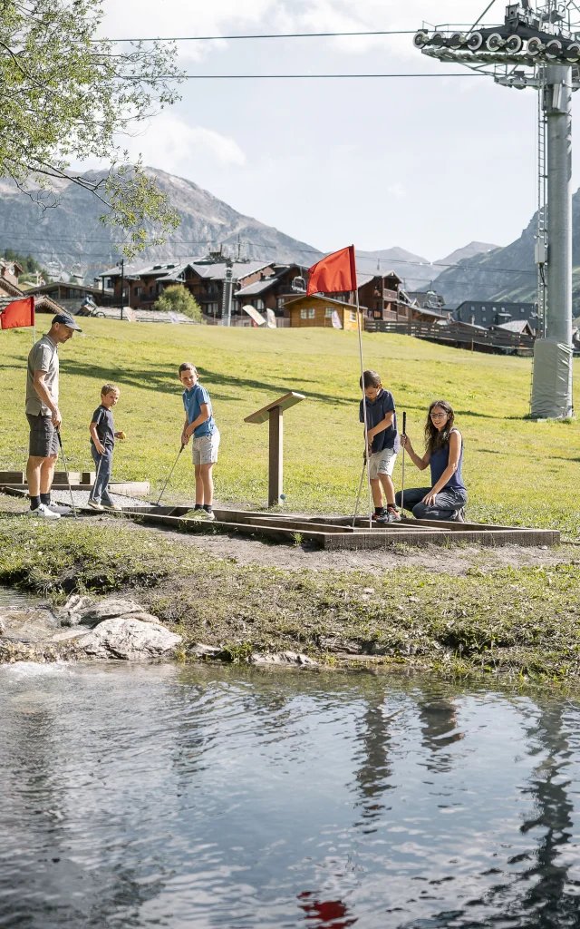 Family mini golf (parents and children) on the Val d'Isère green front in summer